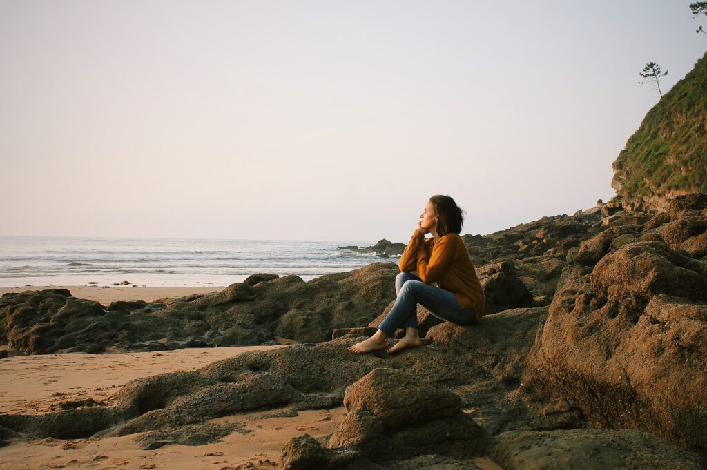 Woman sitting on a rock, managing thoughts 
The Kristi Jones Show Podcast:  It's Time for a Glow Up: Tips on Becoming Your Best Self