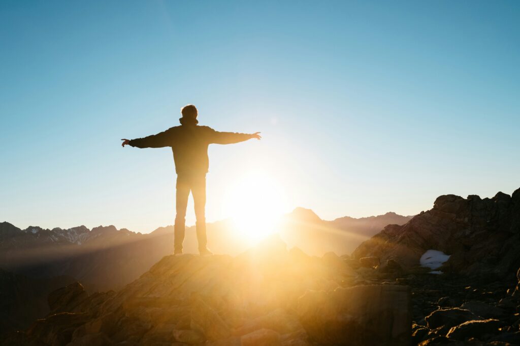 Man standing on mountain with arms spread open

Kristi Jones Podcast Redefining Success
